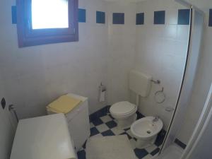 a small bathroom with a toilet and a sink at Residence Marina Blu - Agenzia Cocal in Caorle