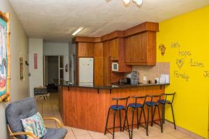a kitchen with a counter and stools in a room at Sea View Holiday Flat - 16 La Luce Margate in Margate