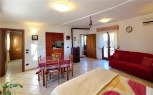 a living room with a red couch and a table at Il Giardino dei Gigli in Meta