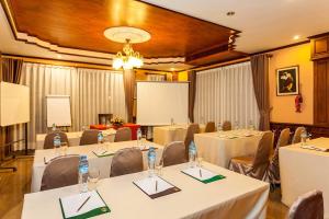 a conference room with tables and chairs and a podium at Chandara Boutique Hotel in Vientiane +60 photos