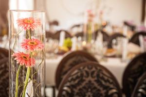 a vase with flowers in it sitting on a table at Pension Belascu in Sibiu