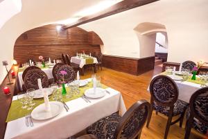 a dining room with tables and chairs in a restaurant at Pension Belascu in Sibiu