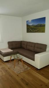a living room with a couch and a coffee table at Appartments Waldblick in Campo Tures