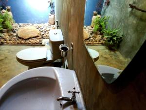 a bathroom with a sink and a fish tank at Ancient Gardens - Villa in Pinnawala