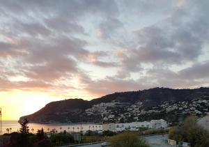 a view of a city and the ocean at sunset at Pension los Verdiales in La Herradura
