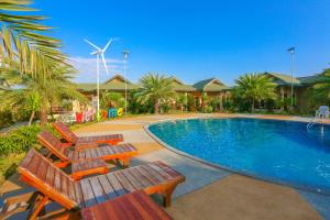 班菲的住宿－環松塔里度假村，一个带两把椅子和风车的游泳池