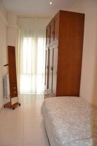 a bedroom with a bed and a cabinet and a window at Placido Apartment in Manresa