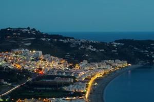 a view of a city at night with lights at Pension los Verdiales in La Herradura