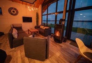 a living room with a couch and a fireplace at Ferienhaus "Chalet100" in Löbnitz