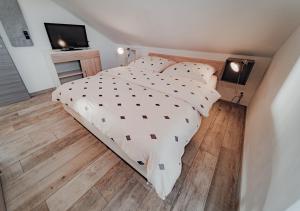 a bedroom with a bed and a television in it at Ferienhaus "Chalet100" in Löbnitz