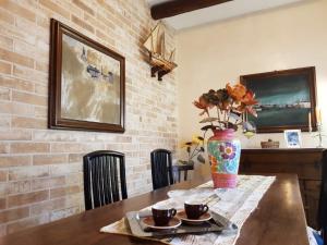 a dining room table with a vase with flowers on it at Villa Lorenzo primo piano in Camaiore