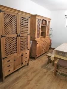 a room with wooden cabinets and a table at Casal do Vulcão in Capelo