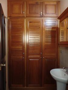a bathroom with wooden cabinets and a sink at Sweet Dreams in Coco +10 photos