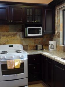 a kitchen with a white stove and a microwave at Sweet Dreams in Coco