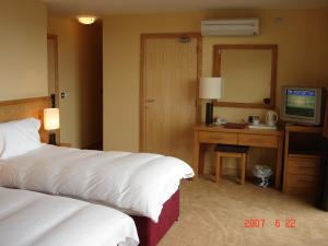 Voodi või voodid majutusasutuse Upton Court Hotel toas