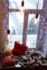 a window with a bunch of pillows and lights at Matryoshka apartment in Khabarovsk