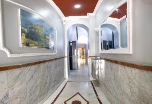 a hallway with two mirrors in a building at Hotel Anfiteatro Flavio in Rome