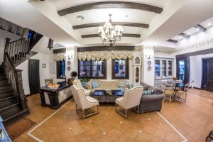 a living room filled with furniture and a chandelier at Conacu´ Boierului in Ponoarele