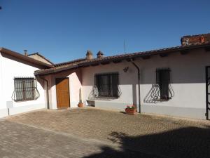 a white house with black windows and a door at Domus Amica in Lu