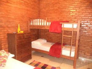 a bedroom with two bunk beds and a ladder at Chales Recanto das Seriemas in São Roque de Minas