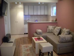 a living room with a couch and a table at Orhidea House in Ohrid