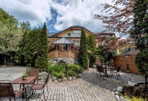 a house with a patio with tables and chairs at Pensjonat Beskidzki in Bielsko-Biała