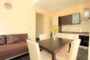 a kitchen and living room with a table and a couch at D&A Apartments in Vela Luka