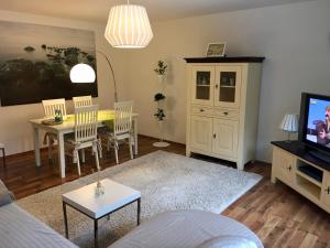 ein Wohnzimmer mit einem Tisch und einem Esszimmer in der Unterkunft Ferienwohnung "Am Nordertor" in Flensburg