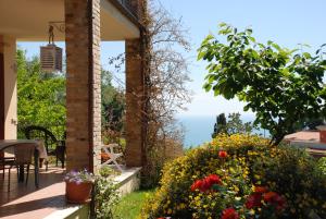 a house with a balcony with a view of the ocean at Bed & Breakfast Latteletto in Tortoreto Lido +8 photos