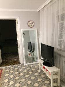 a living room with a tv and a mirror at Holiday house near sea on Lvovskaya in Odesa +3 photos