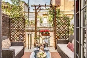 a patio with two couches and a table at Pantheonview - Luxury Suites in Rome