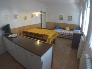 a room with a bedroom with a bed and a desk at Casa Francesca - Agenzia Cocal in Caorle