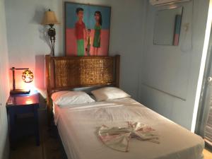 a bedroom with a bed with a bow on it at Hotel El Casino in Casares +59 photos