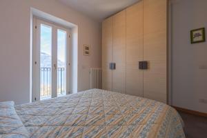 a bedroom with a bed and a large window at Casa Amarilla in San Siro