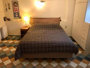 ein Schlafzimmer mit einem Bett und einem Tisch mit einer Lampe in der Unterkunft Piraeus Lux Secret in Piräus