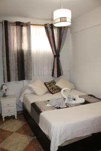 a bedroom with two beds and a window at Casa Vega in Benidorm