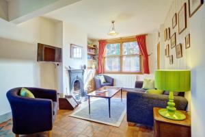 a living room with a couch and a table at St Johns House in Ely