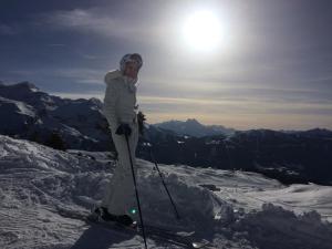 a person on skis standing on top of a mountain at Boutique Chalet Panoramic Views Hot Tub in Vers L'Eglise