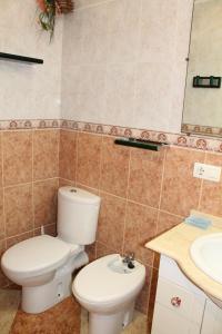 a bathroom with a toilet and a sink at Casa Vega in Benidorm