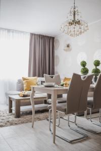 a living room with a table and chairs and a couch at Apartament Hubalczyków in Słupsk