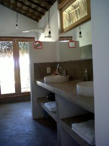 a bathroom with two sinks and a mirror at Casa da Gwen in Jericoacoara