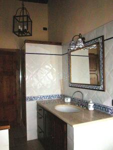 a bathroom with a sink and a mirror at Casale delle Due Fonti in San Venanzo