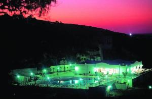 a building with a swimming pool at night at Villaggio San Lorenzo in Vieste