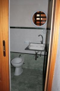 a bathroom with a sink and a toilet at porta marina ortigia in Siracusa +13 photos