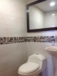 a bathroom with a toilet and a sink at Apartamentos Cartagena in Cartagena de Indias