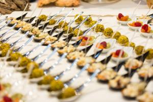 a buffet of food on a table with appetizers at Hotel Mediterraneo in Sottomarina