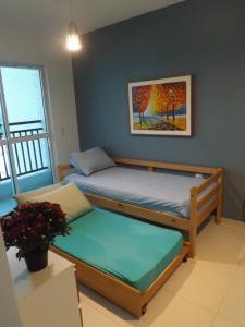 a bedroom with two beds and a painting on the wall at Smart Residence Flat - 509 in Teresina