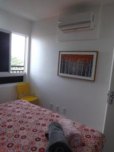 a bedroom with a bed and a picture on the wall at Smart Residence Flat - 509 in Teresina