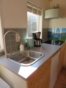 a kitchen counter with a sink and a window at Casa Koudekerke in Koudekerke +15 photos