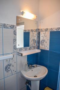 a bathroom with a sink and a mirror at Pensiunea Arizona in Corbeni +99 photos